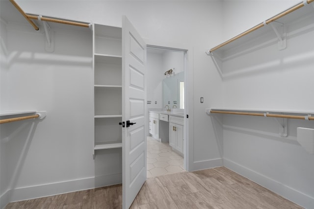 spacious closet featuring light hardwood / wood-style flooring