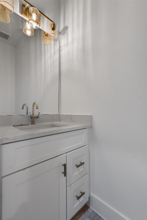 bathroom featuring vanity and hardwood / wood-style floors