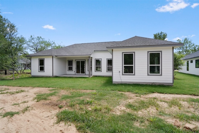 back of house with a lawn