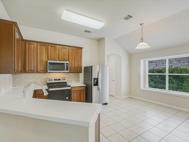 kitchen with light tile patterned flooring, lofted ceiling, pendant lighting, stainless steel appliances, and decorative backsplash