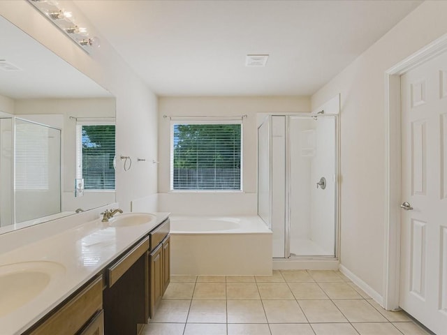 bathroom featuring tile patterned floors, plus walk in shower, and vanity