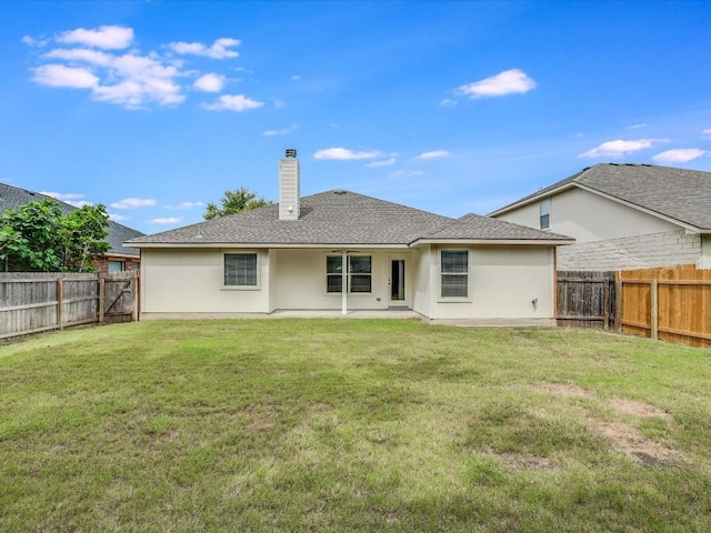 rear view of property featuring a patio and a lawn