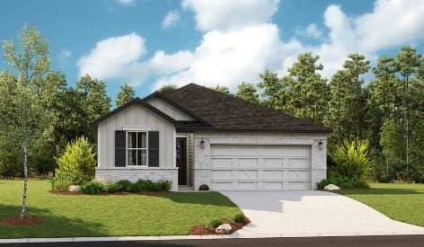 view of front of house featuring a front lawn and a garage