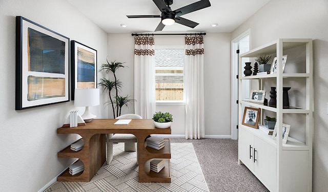 office space with light colored carpet and ceiling fan