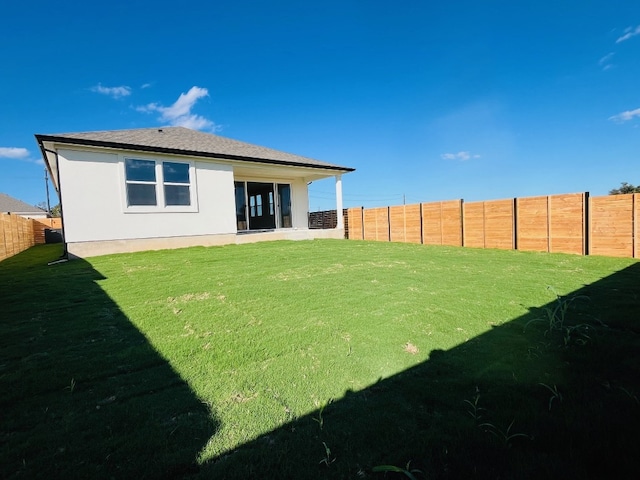 back of property featuring a lawn