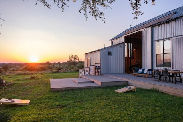 yard at dusk featuring a deck