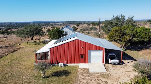 view of outdoor structure featuring a yard, a garage, and a carport