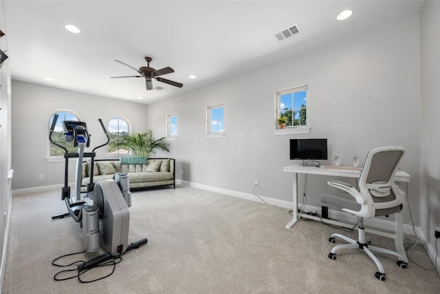 carpeted office space with ceiling fan