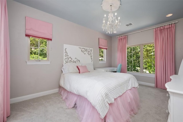 bedroom featuring light colored carpet and a notable chandelier