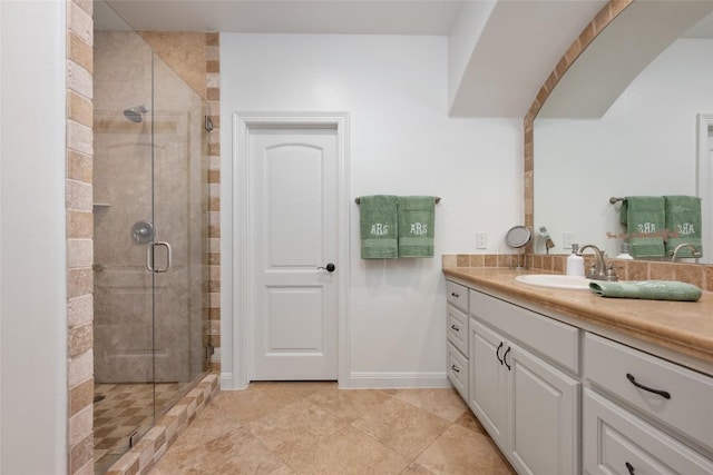 bathroom featuring vanity and an enclosed shower