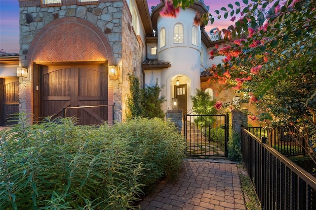 view of exterior entry at dusk