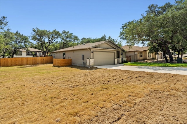 view of front of house with a garage and a front lawn