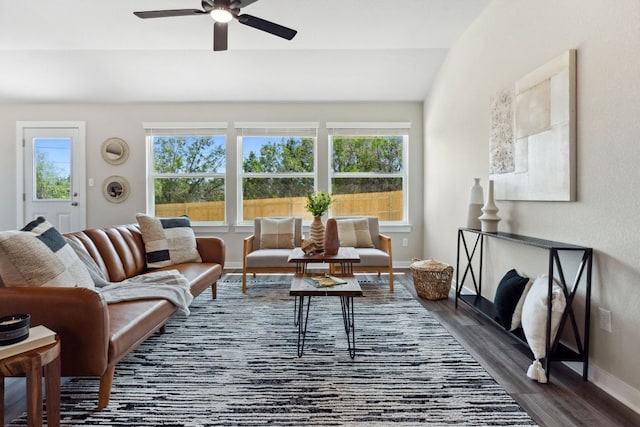 living room with lofted ceiling, dark wood-type flooring, and ceiling fan