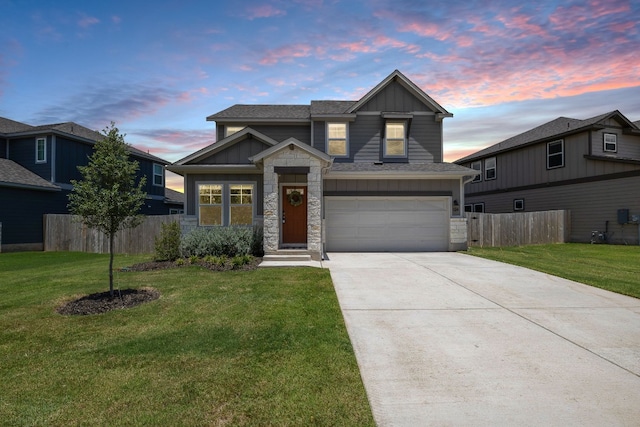 view of front of property with a garage and a yard