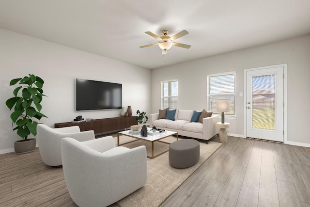 living area with a ceiling fan, baseboards, and wood finished floors