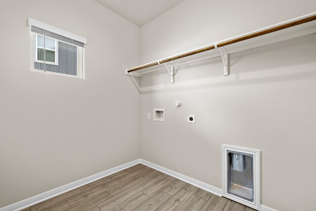 clothes washing area featuring hardwood / wood-style flooring, electric dryer hookup, hookup for a washing machine, and hookup for a gas dryer