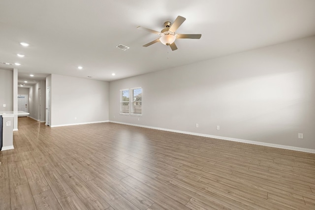 empty room with light hardwood / wood-style floors and ceiling fan