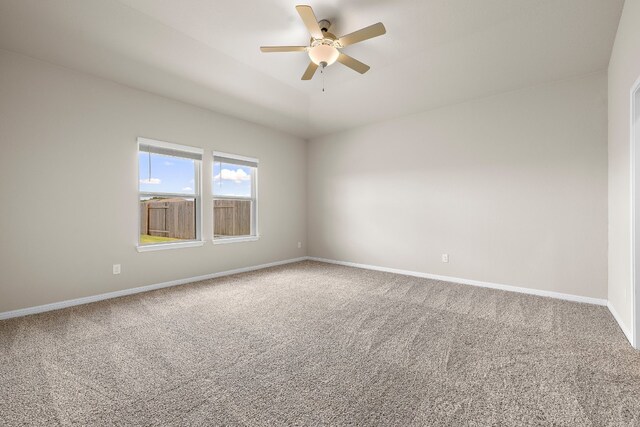 carpeted spare room with ceiling fan