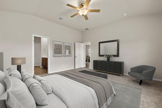 carpeted bedroom with ceiling fan, lofted ceiling, and ensuite bathroom