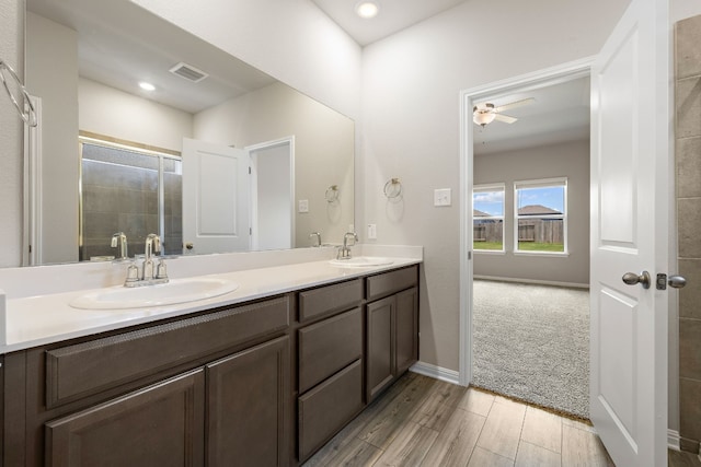 bathroom featuring an enclosed shower, ceiling fan, vanity, and hardwood / wood-style flooring