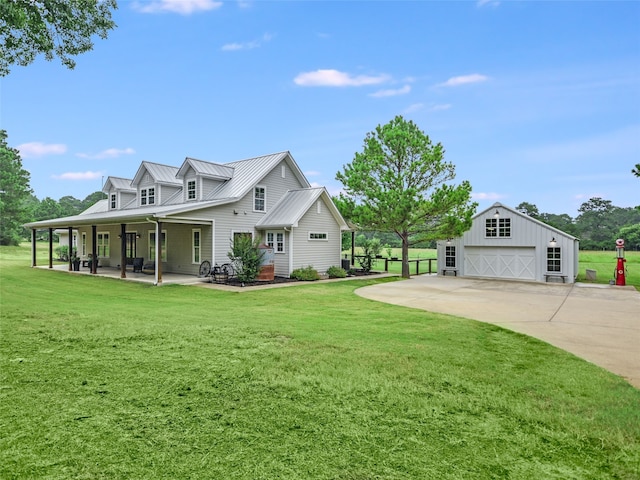 view of home's exterior featuring a lawn, a porch, a garage, and an outdoor structure