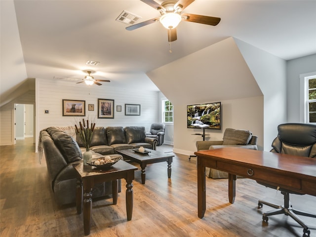 office area featuring ceiling fan, vaulted ceiling, and light hardwood / wood-style flooring