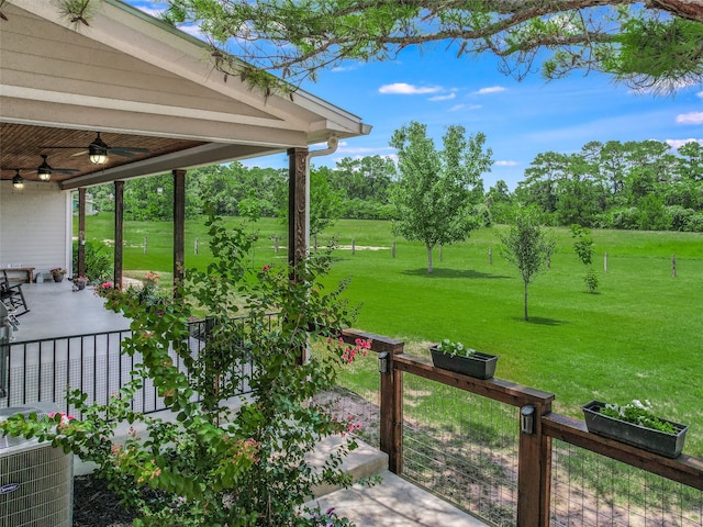 view of yard with ceiling fan and central AC