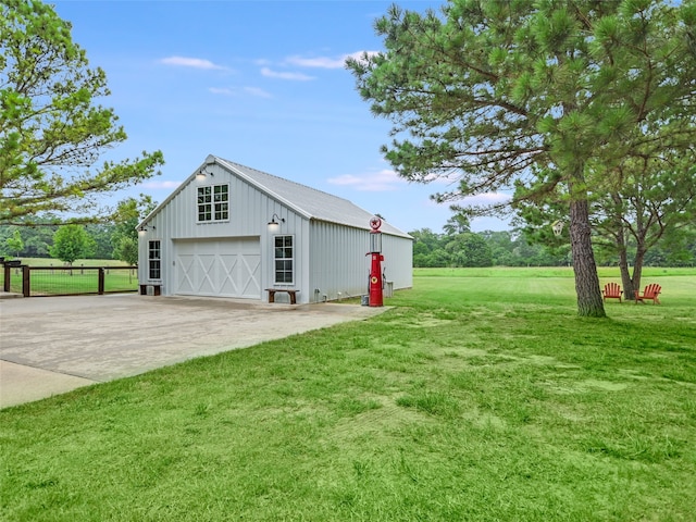 view of property exterior with a yard, a garage, and an outbuilding