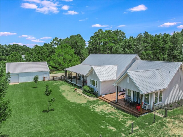 back of house featuring a yard and a deck