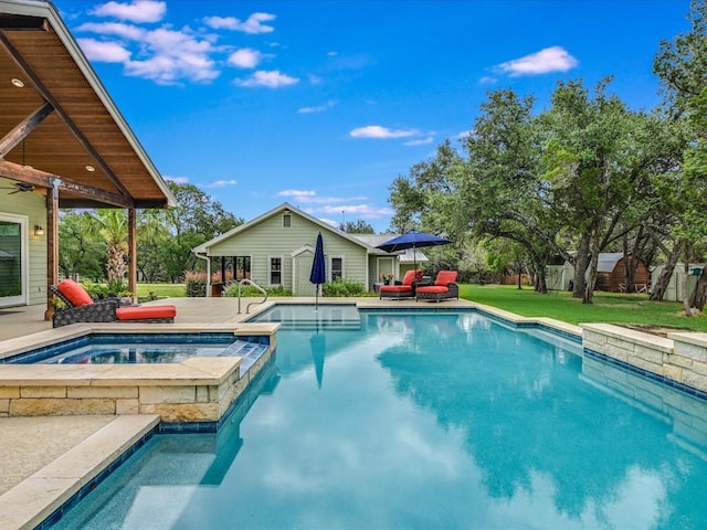 view of pool with an in ground hot tub and a lawn