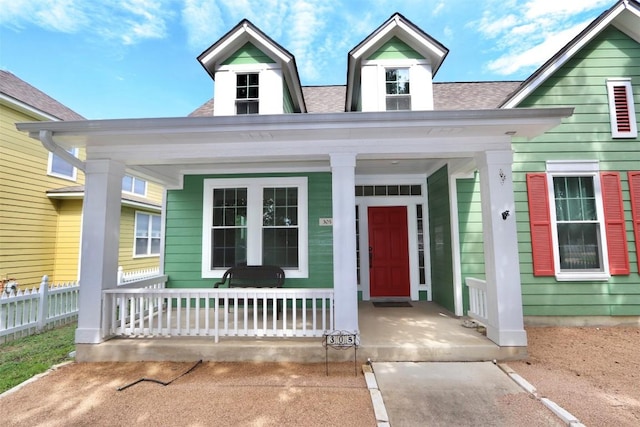 view of exterior entry featuring a porch