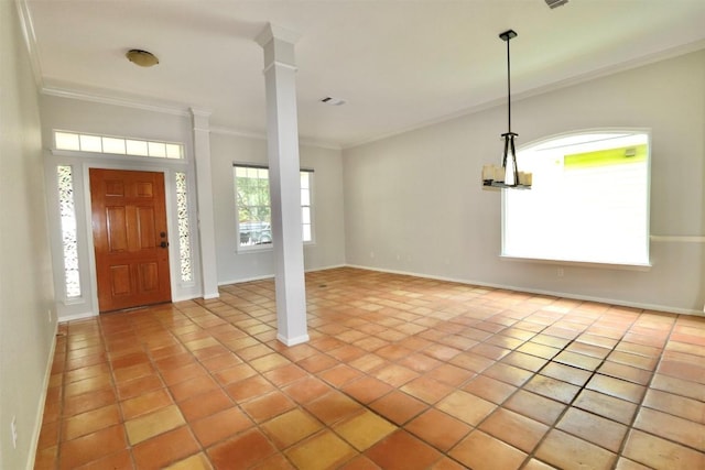 entrance foyer featuring decorative columns, a wealth of natural light, ornamental molding, and light tile patterned flooring