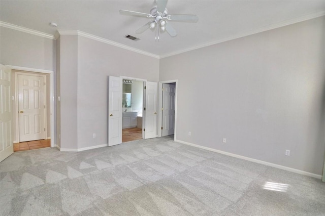 unfurnished bedroom with light carpet, ensuite bath, ceiling fan, and ornamental molding