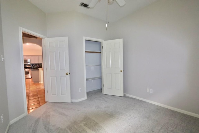 carpeted bedroom with ceiling fan and high vaulted ceiling