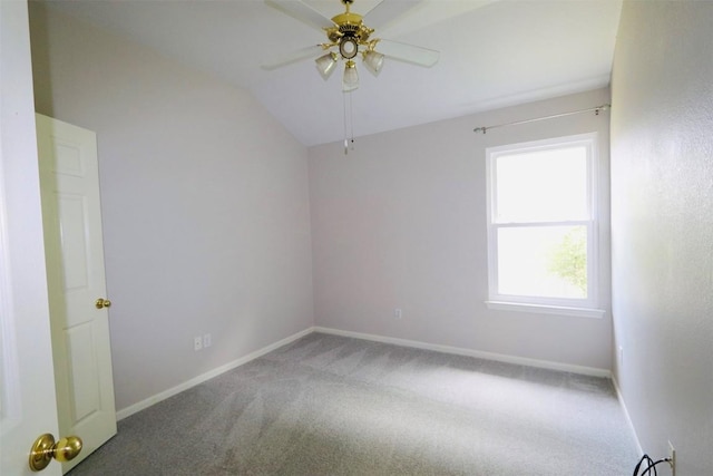 carpeted spare room featuring ceiling fan and lofted ceiling