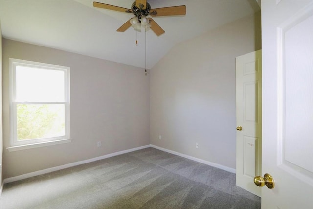 spare room with carpet, ceiling fan, and vaulted ceiling