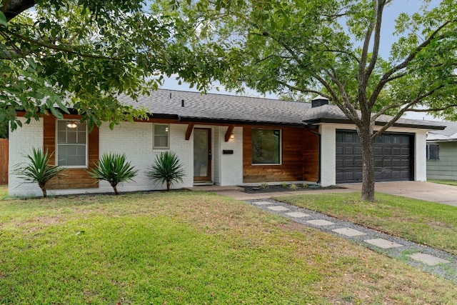 ranch-style home featuring a garage and a front yard