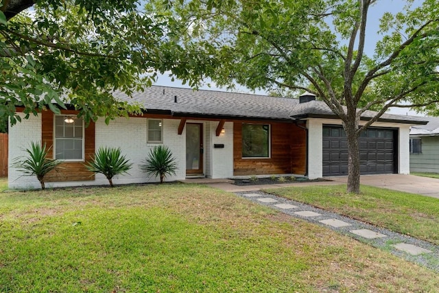 single story home with a garage and a front lawn