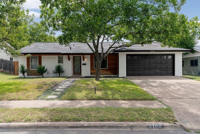 single story home with a garage and a front lawn