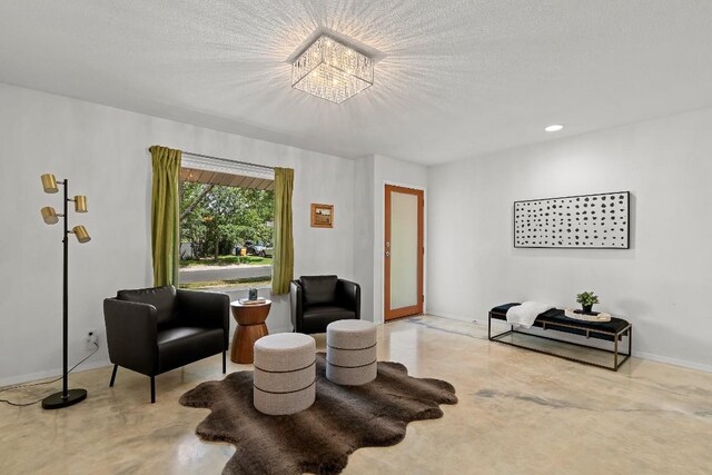 sitting room featuring concrete flooring and a textured ceiling