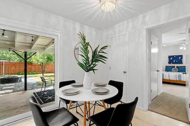 dining area featuring ceiling fan with notable chandelier