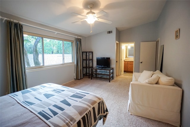 carpeted bedroom featuring lofted ceiling, ceiling fan, and connected bathroom