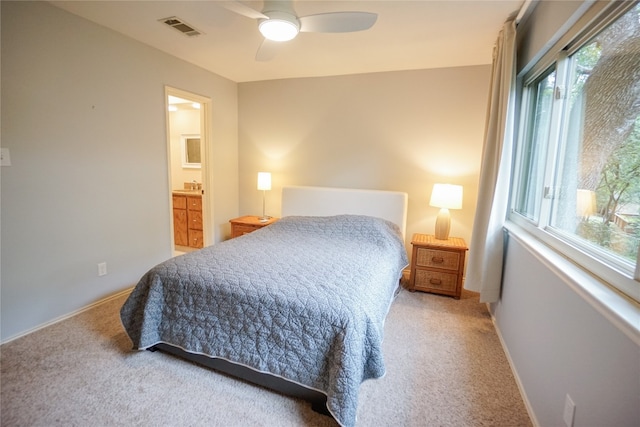 carpeted bedroom featuring ensuite bathroom and ceiling fan