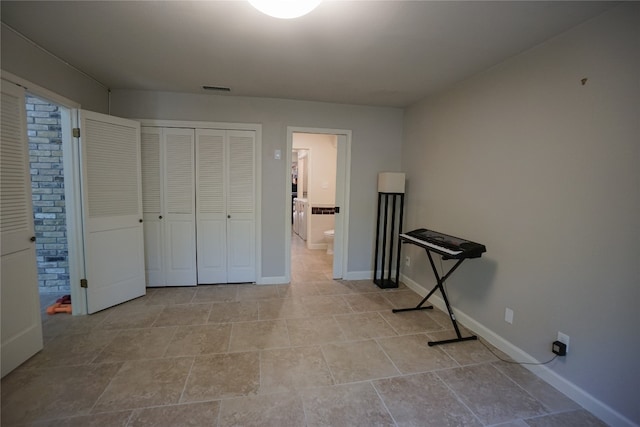 bedroom featuring connected bathroom and a closet