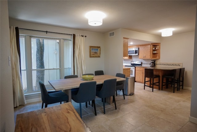 dining area with light tile patterned floors