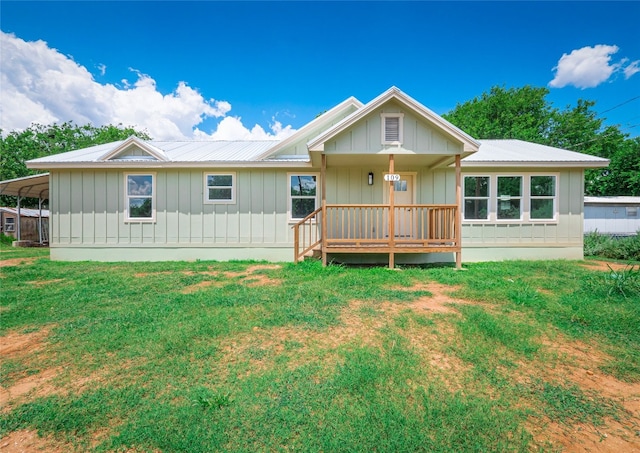 back of property featuring a porch and a yard