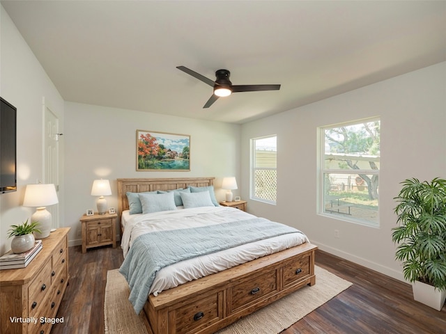 bedroom with dark hardwood / wood-style flooring and ceiling fan