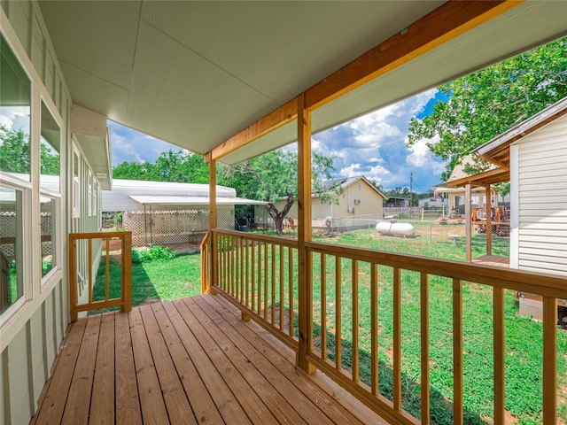 wooden deck featuring a yard