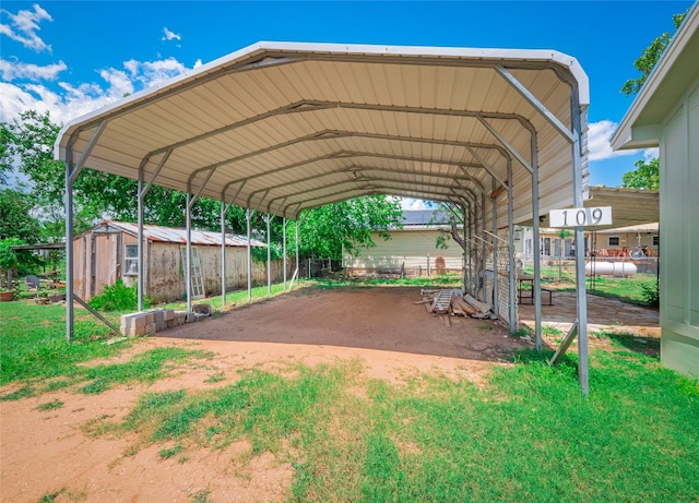 view of car parking with a carport and a yard