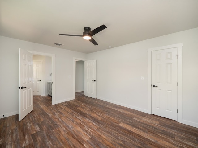 unfurnished bedroom featuring ceiling fan and dark wood-type flooring